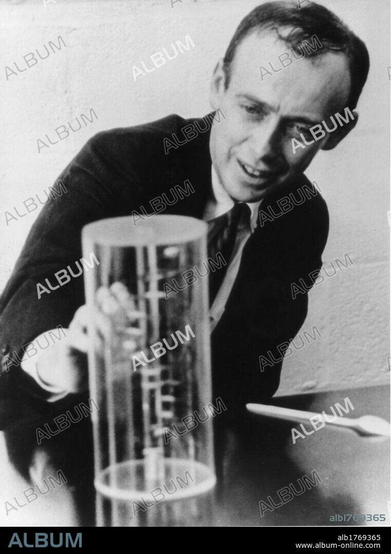 James Watson watching a DNA model. The american biologist James Watson watching a reproduction of the DNA double helix discovered by him. USA, 18th October 1962.