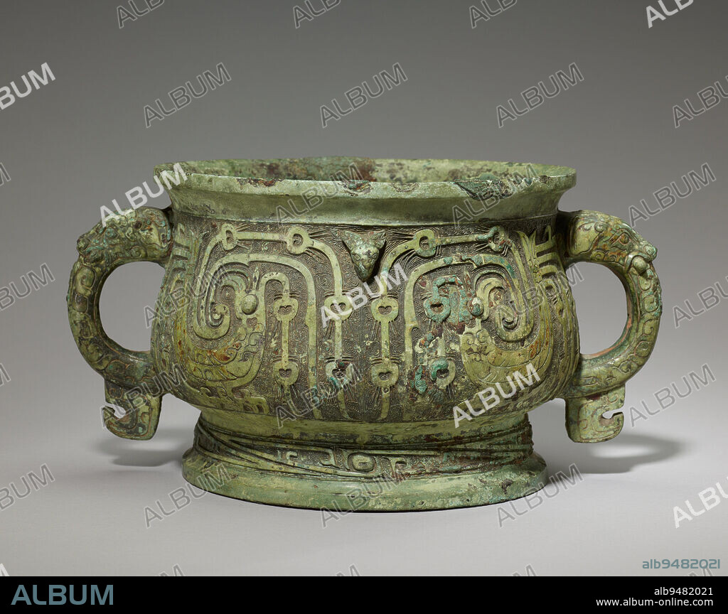 Gui food vessel, 10th century BCE, 6 1/4 × 11 7/8 × 8 13/16 in., 9.5 lb. (15.8 × 30.2 × 22.4 cm, 4.3 kg), Bronze, China, 10th century BCE, Toward the midWestern Zhou, two of the most noticeable changes that occurred in bronze casting involved the abandonment of the taotie (composite animal) mask motif and the adoption of long inscriptions. This gui displays elaborate birds, a popular motif, on its main decorative register. The birds flamboyant design, with their crests and peacock-like plumage, is unique. The lengthy inscription, neatly cast into the cauldrons bottom, reads as follows.