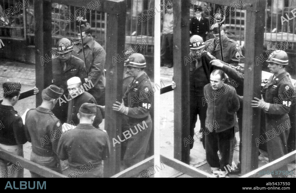 Germans Hanged For Killing U.S. Files -- two German civilians stand on the gallows at Bruchsal Prison, Germany awaiting execution for the murder of six American fliers who parachuted from a disabled plane in 1944. In all five Germans were executed for the same crime. At the right, Johann Seipel. The first to be hanged, has hood and noose placed over his head before the trap is sprung. At the left, Johann Opper, second to die, hears order for his execution read. November 21, 1945. (Photo by AP Wi.
