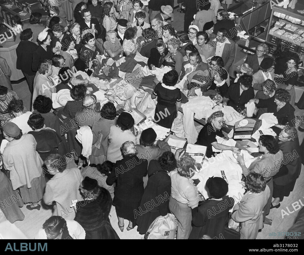 Los Angeles, California:  c. 1951 Women shoppers crowd a shopping sale counter at Ohrbach's department store   © Underwood Archives / The Image Works.
