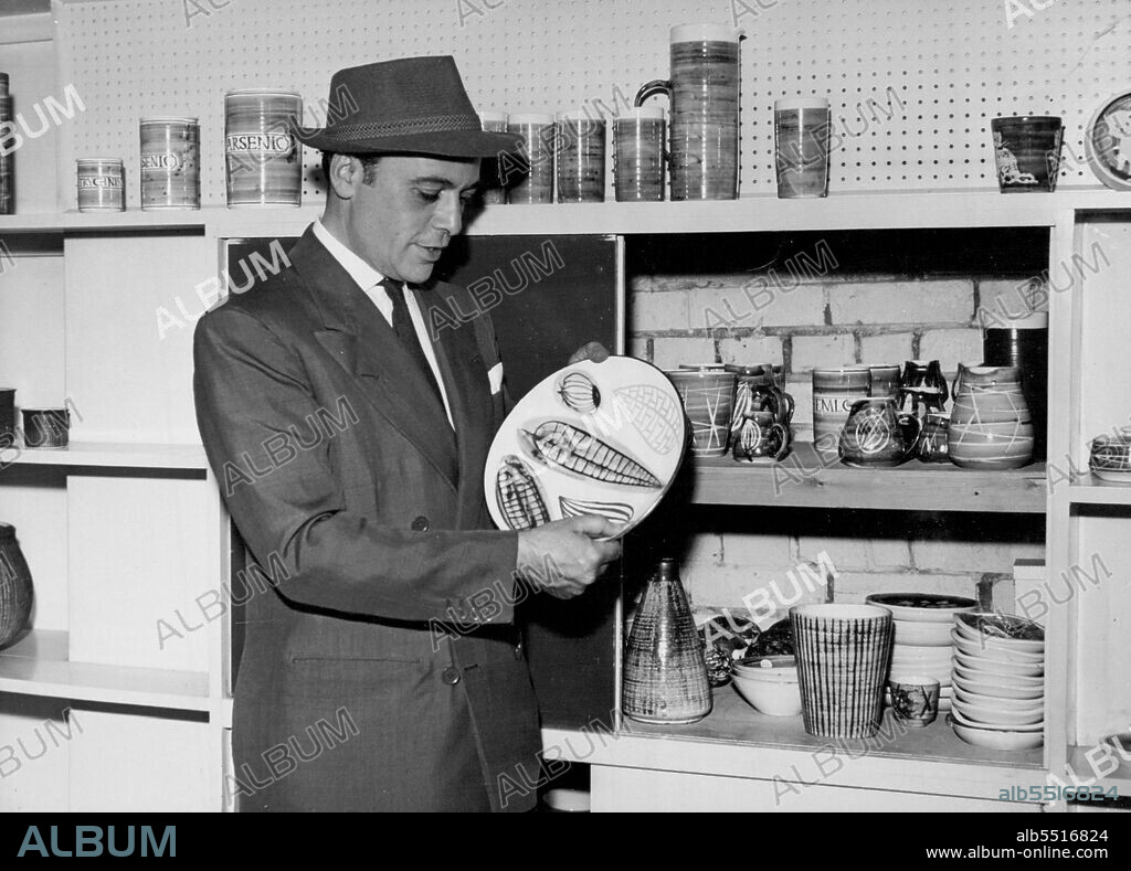 The Actor Admires The Pottery - Actor and pottery expert Herbert Lom inspects a fine piece of Briglin Pottery at the company's premises in Baker Street. A new kind of pottery of an individual and creative nature is gradually making itself felt at the Briglin Pottery Company, (run by Mrs. Brigitta Apple by and Mrs. Lewenstein) turns out its fine work on its Baker Street (London WI) premises. Some of the firm's special pieces are now travelling the U.S.A. representing British pottery. July 14, 1938. (Photo by Fox Photos).