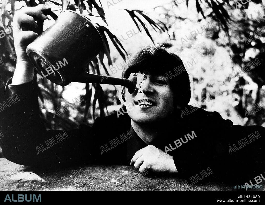 John Winston Ono Lennon, MBE, born October 9, 1940, murdered December 8, 1980, was an English songwriter, singer, musician, graphic artist, author and peace activist who gained worldwide fame as one of the founders of The Beatles.  PICTURED: (File Photo: Date Unknown) Actor Composer Director JOHN LENNON (1940-1980) watering the flower in his eye. 08/12/2005