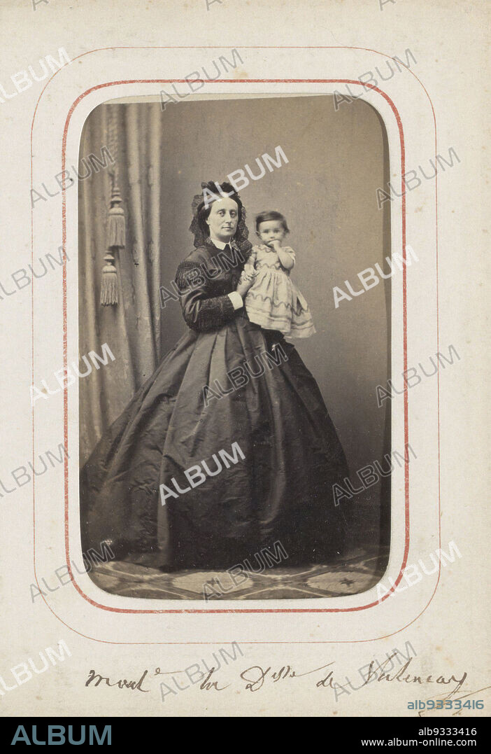 Portrait of noblewoman De Valencay with Dolly on her arm, Delle. de Valencay et Dolly (title on object), This photo is part of an album., A. Schamberg, Germany (possibly), c. 1860 - c. 1865, cardboard, paper, albumen print, height 95 mm × width 60 mm.