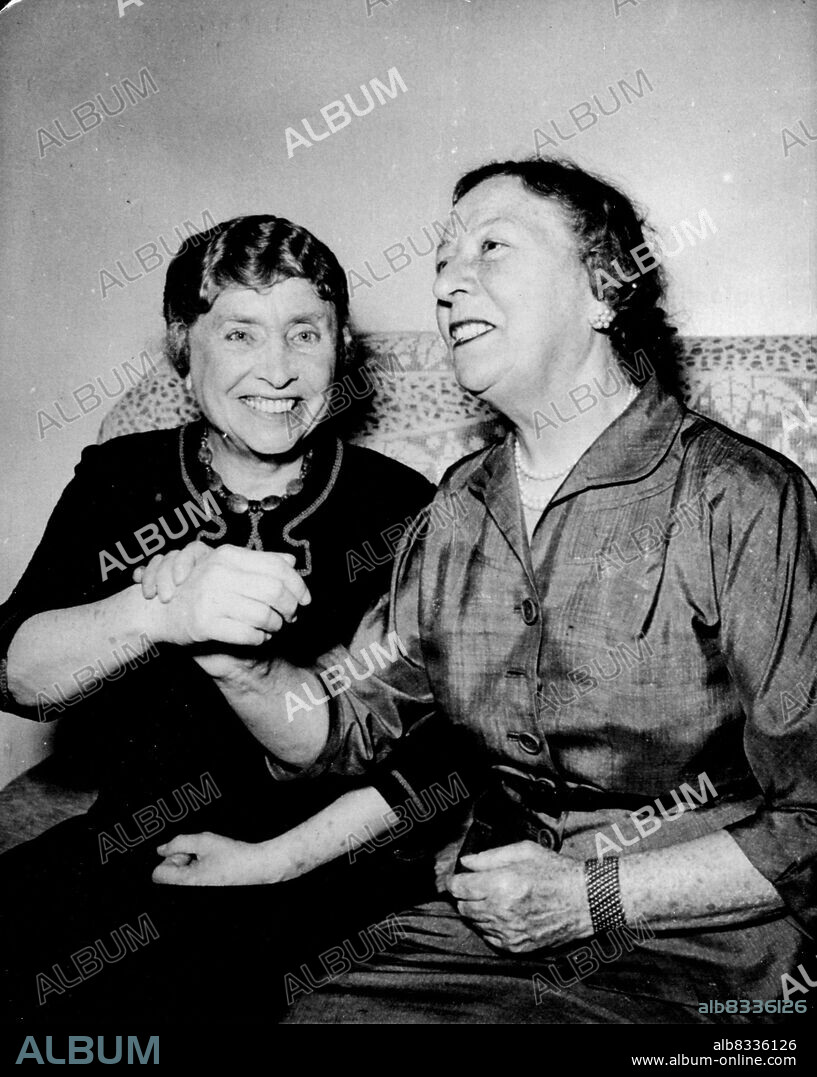 Deaf And Blind Authoress In Middle Easter - Miss Helen Keller (left), 71, the American blind authoress speaks through her friend Miss Polly Thomson, Glasgow-born American, at a news conference in Cairo's hotel Semiramis, April 14. Miss Keller is on a three-month tour of schools, workshops and institution for the blind in the Middle East. She was born at Tuscumbiai, Alabama, and has been deaf and blind since the age of 19 months. April 21, 1952. (Photo by Associated Press Photo).
