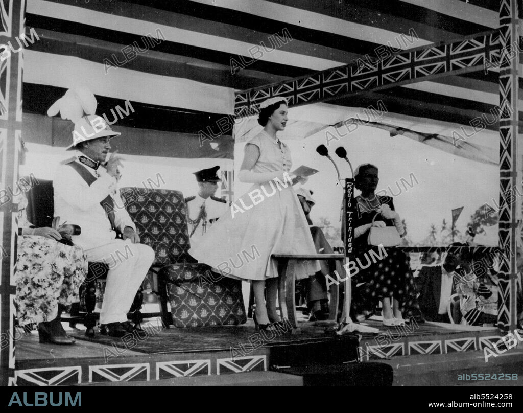 Princess Margaret In Trinidad -- Her skirt billowing in the breeze, Princess Margaret makes a charming picture as she replies to the welcome address by the Mayor of Arima. On the platform with the Princess is Sir Hubert Rance, Governor of Trinidad. Trinidad is the first stop in the Princess's tour of the British Caribbean. February 1, 1955. (Photo by London Express News And Features Service).