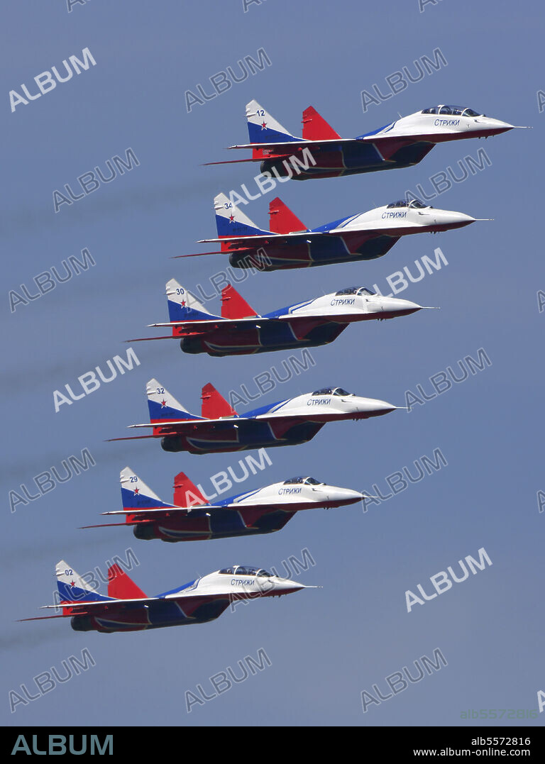 MiG-29 jet fighters of the Russian Swifts aerobatics team during demonstration flight, Kubinka, Russia.