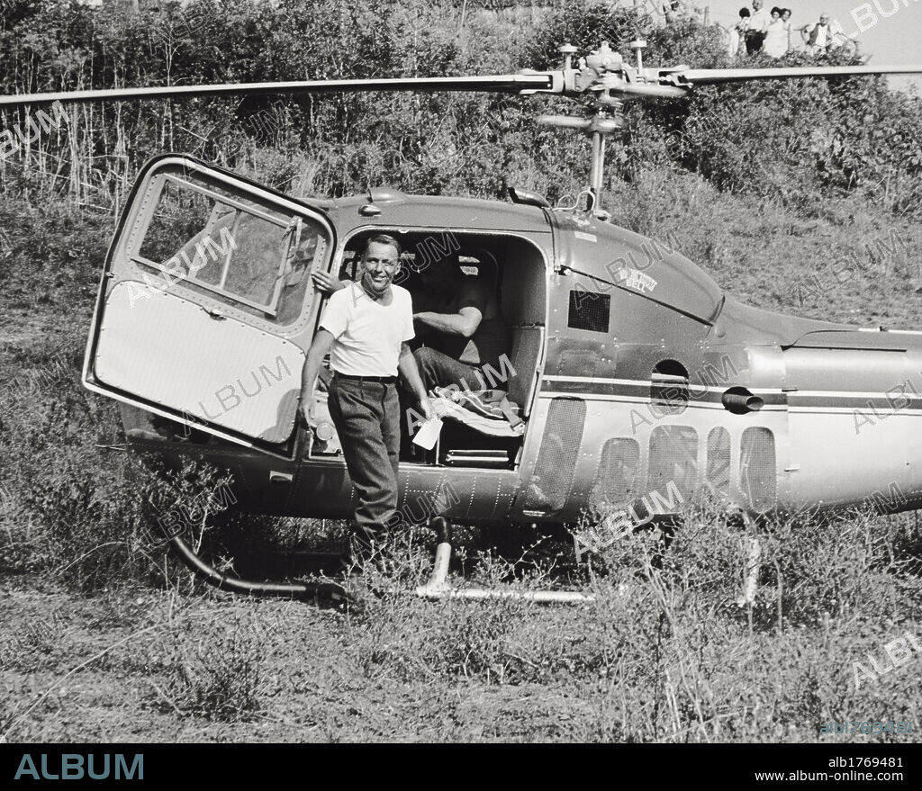 Frank Sinatra next to a helicopter. The Italian-American singer and actor Frank Sinatra posing in front of a helicopter on the set of 'Von Ryan's Express'. Italy, August 1964.