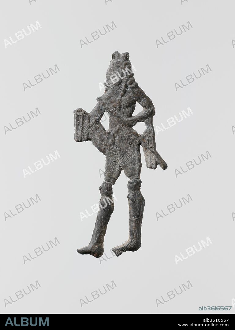 Lead figure of a man with a spear or scepter. Culture: Greek, Laconian. Dimensions: Height: 1 7/8 in. (4.8 cm). Date: 6th-5th century B.C..
Small flat votive figurines of cast lead have been found in great quantities at the ancient sanctuaries of Laconia; over one hundred thousand, dating from the seventh century B.C. to the Classical period, were dedicated to the goddess Artemis Orthia in Sparta.