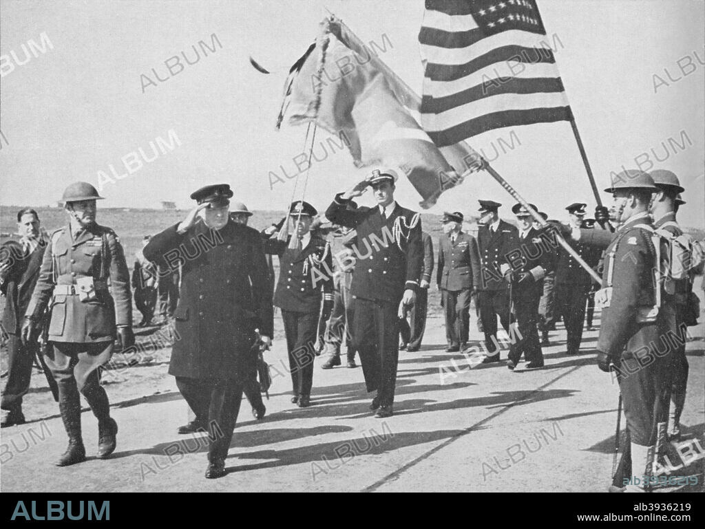 'Iceland visit. Churchill - with Ensign Franklin D. Roosevelt Jnr. following - saluting the Stars and Stripes as he walks among British and U.S. troops and Norwegian sailors', 1941. Winston Churchill's visited Iceland, 16th August 1941, on the return journey from meeting President Roosevelt. From Winston Churchill: Man of Destiny, by H. Stafford Northcote. [Newnes, London, 1965].