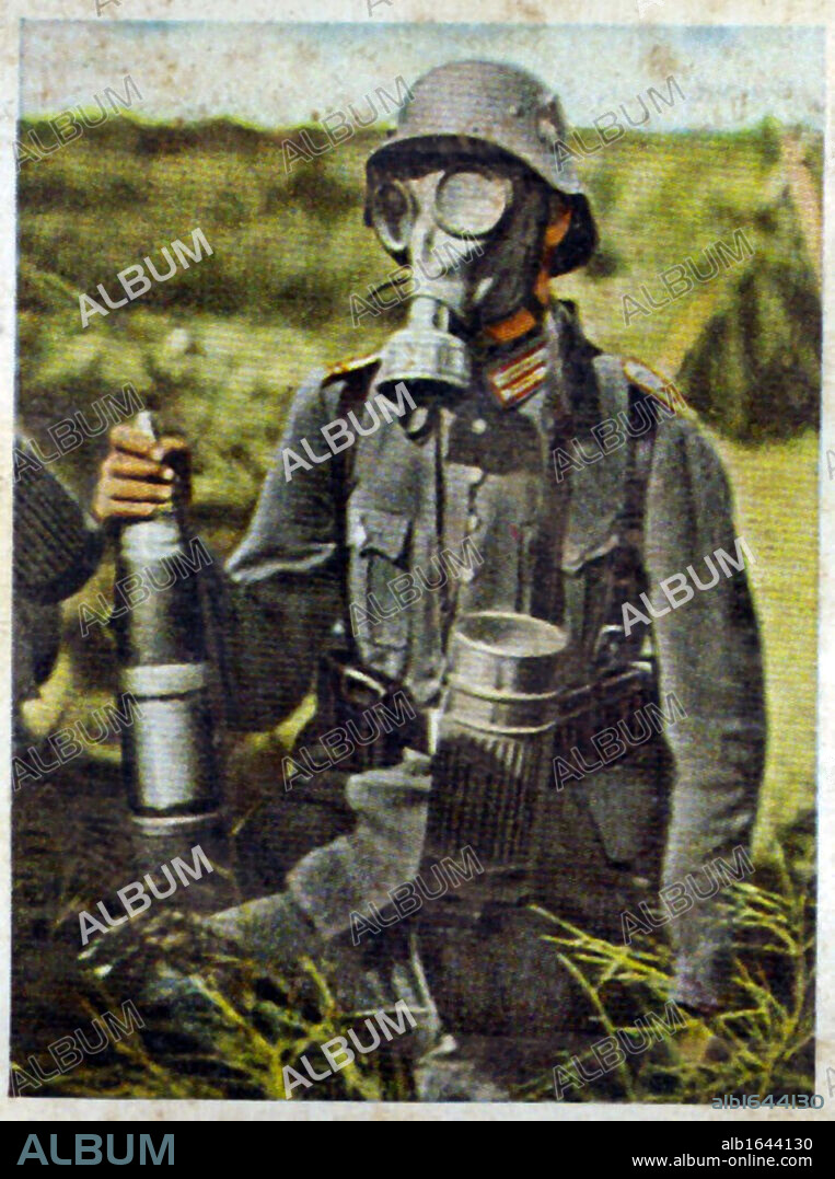 German re-armament and militarisation: Chemical warfare preparation. A gunner, holding a shell, on exercises wearing a gasmask. From series of 270 cigarette cards 'Die Deutsche Wehrmacht', Dresden, 1936.