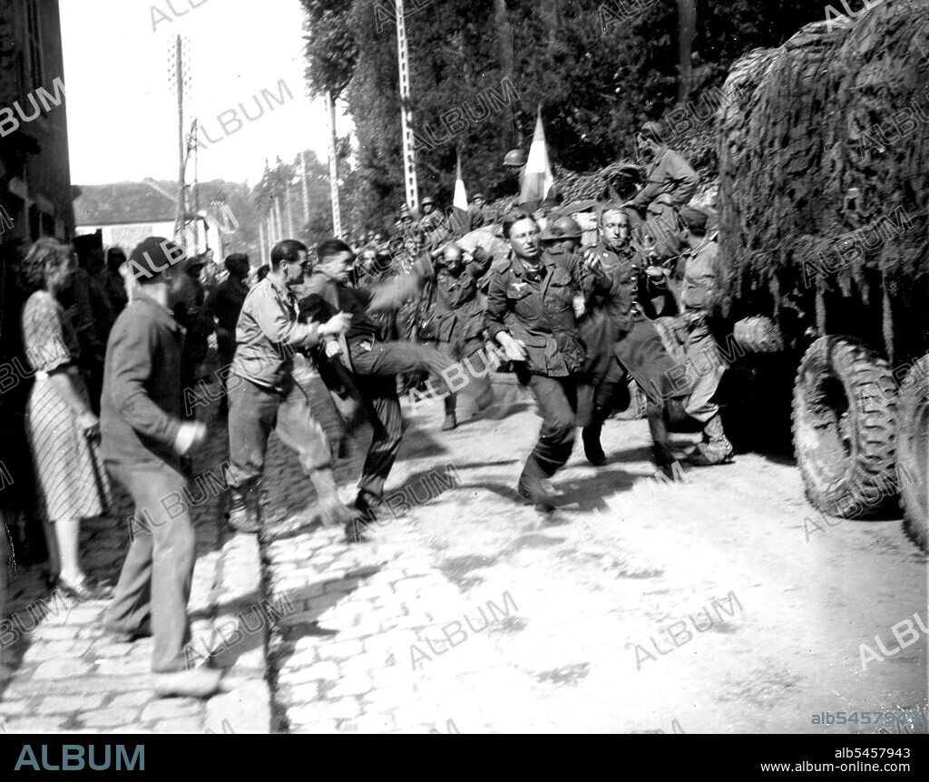 German Prisoners of FFI -- French patriots Kick and Jeer at German  prisoners, rounded up by French Forces of the Interior, as they march  through the town of Jouy-En-Josas, - Album alb5457943