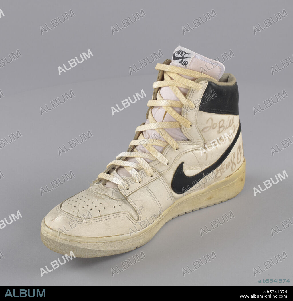 African-American basketball player George Gervin (born 1952), 'the Iceman', played in both the American Basketball Association and National Basketball Association for the Virginia Squires, San Antonio Spurs, and Chicago Bulls. He was named as one of the 50 Greatest Players in NBA History. White leather game-worn shoe with black leather accents worn by Gervin. The shoe is for the right foot and features the Nike logo on the sides. Black leather accent at heel of shoe with white type reading: [NIKE / AIR]. The proper left side of the shoe has a handwritten message to Bill Ficke reading: [To Bill / (illegible writing) / George Gerwin / #44].