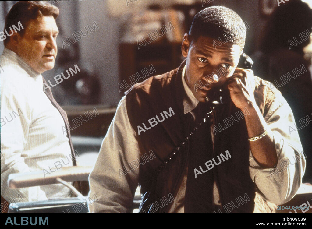 DENZEL WASHINGTON and JOHN GOODMAN in FALLEN, 1998, directed by GREGORY HOBLIT. Copyright WARNER BROTHERS.