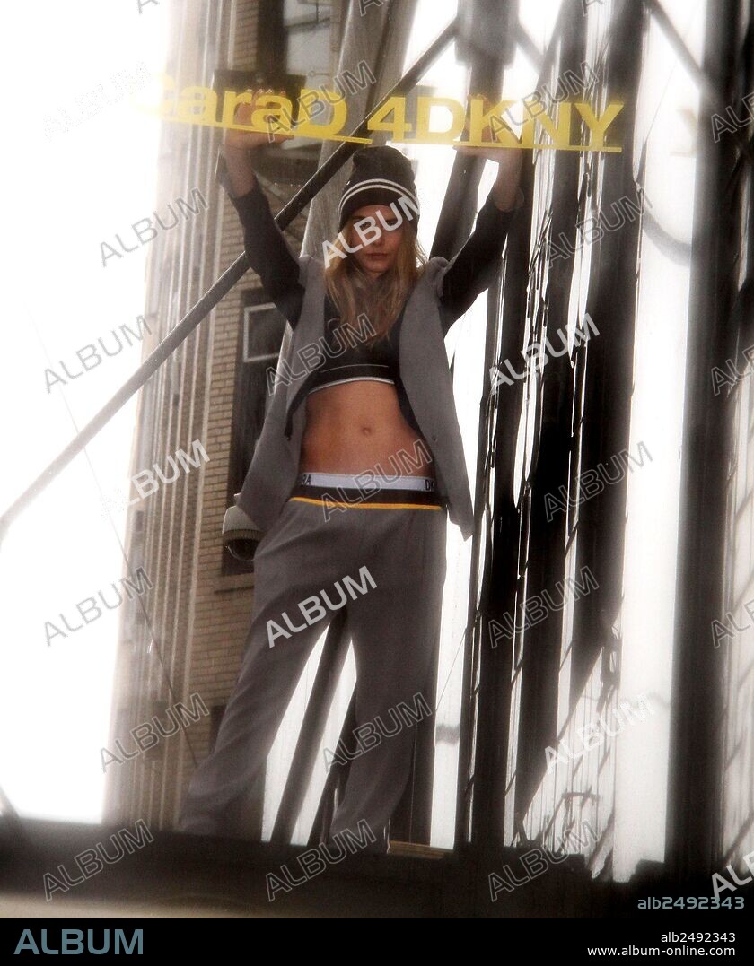 Oct. 10, 2014 - New York, New York, U.S. - Model CARA DELEVINGNE poses in the pouring rain to promote the launch of 'Cara D For DKNY' capsule collection at Bloomingdale's 59th Street. 10/10/2014