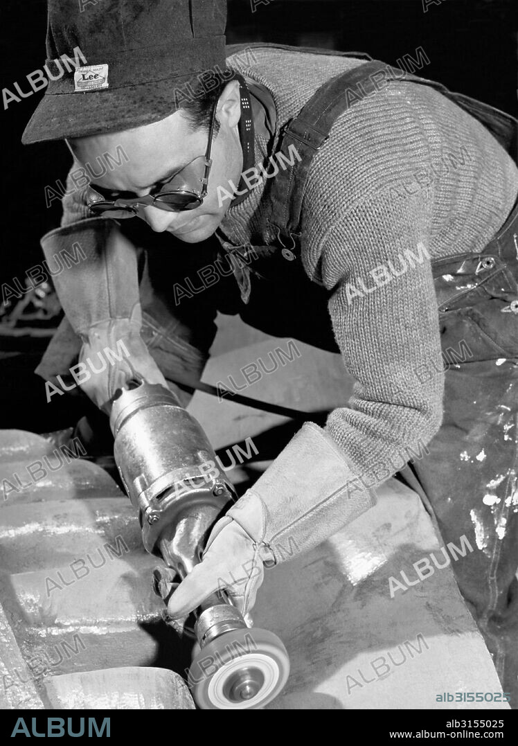 New York, New York:  1940 Isamu Noguchi working on the Associated Press Building Plaque, which was carved in plaster and cast in stainless steel - at that time the largest-ever stainless steel casting.  It is still installed in Rockefeller Center.