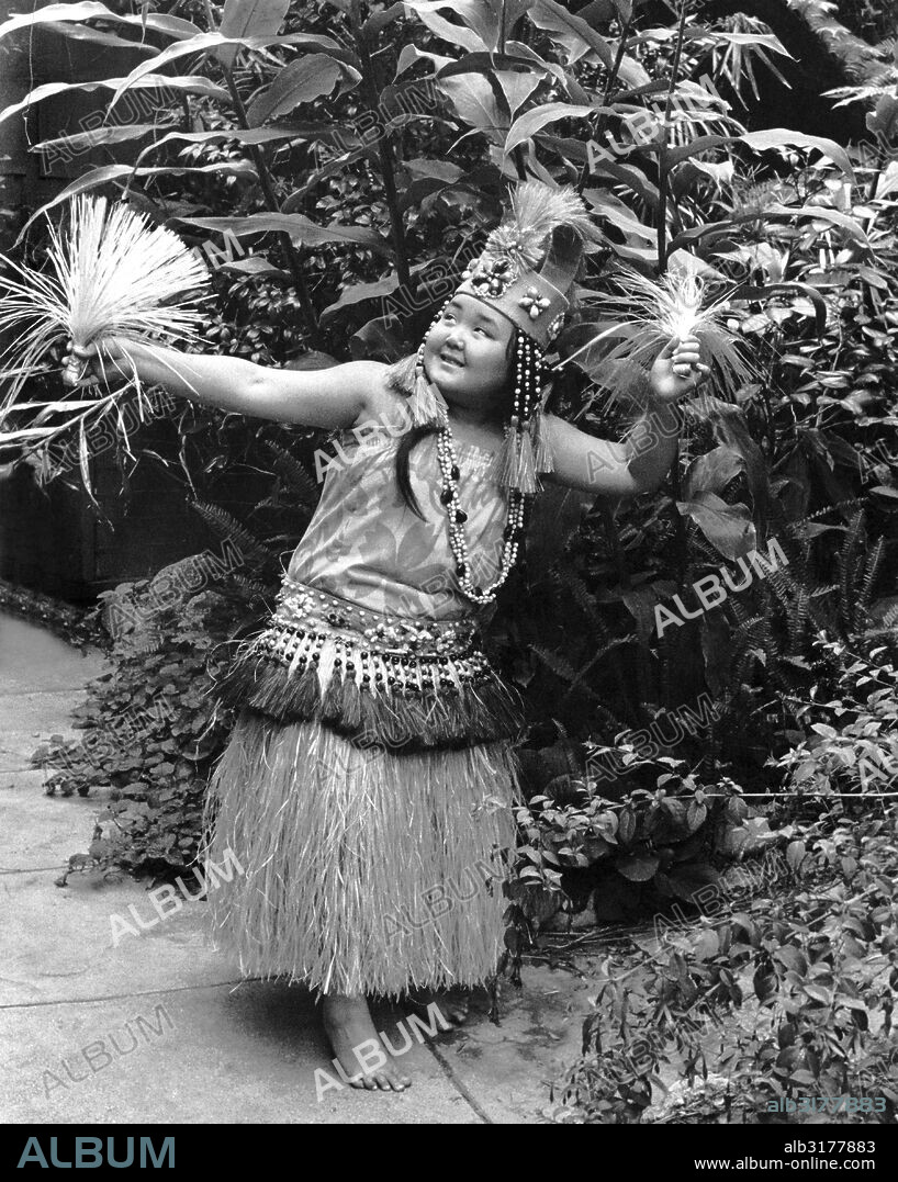 Hawaii:  c. 1955 A young Hawaiian hula dancer performing in her native attire.   © Underwood Archives / The Image Works.