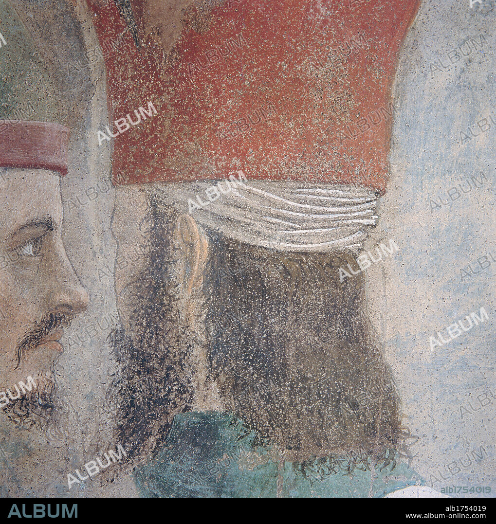 Legend of the Cross: Exaltation of the Cross, by Pietro di Benedetto dei Franceschi known as Piero della Francesca, 1452-1462, 15th Century, fresco. Italy, Tuscany, Arezzo, San Francesco church, Major Chapel, left wall, summit lunette. Detail. Bearded male figure behind with long hair and conical headgear; headdress, on the left.
