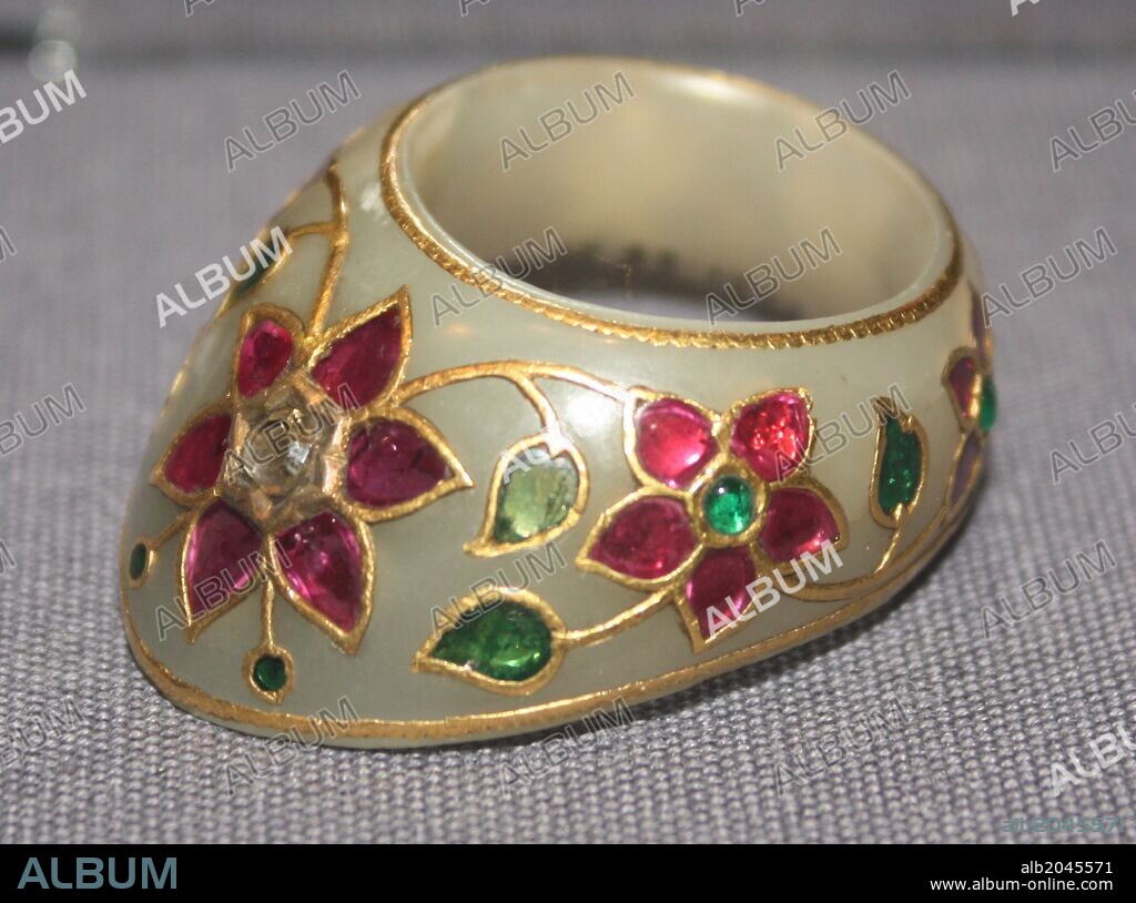 Thumb Ring. Mughal, 17th century. White nephrite jade set with emeralds, rubies and a diamond.