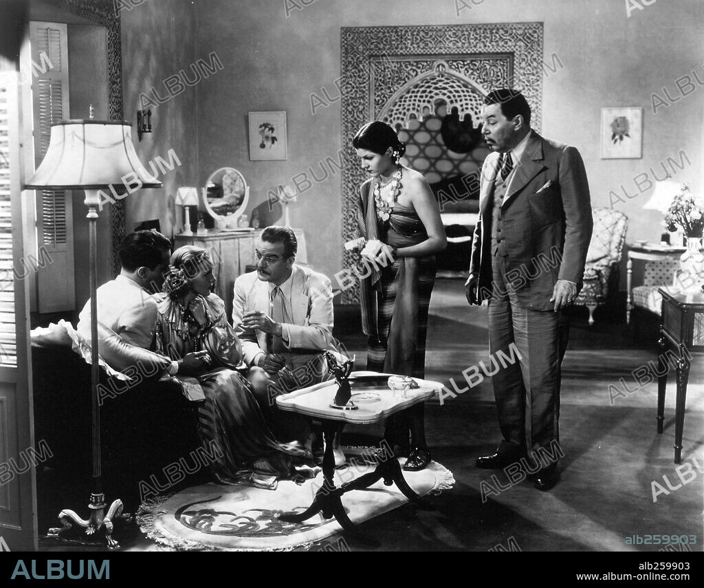 RITA HAYWORTH and WARNER OLAND in CHARLIE CHAN IN EGYPT, 1935, directed by LOUIS KING. Copyright FOX FILMS.