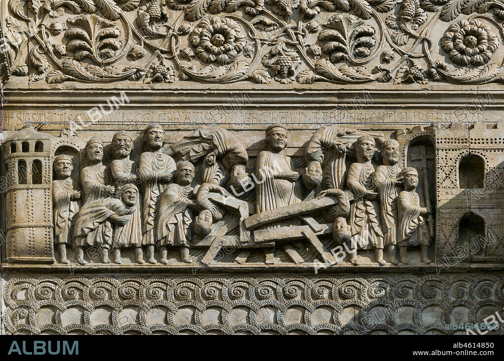 Fidenza, Duomo (St. Donnino Cathedral), Façade: the bas-relief with Stories of San Donnino, "The Miracle of the Pregnant Woman", which dramatically tells the story of the collapse of an overly crowded bridge and the rescue of the pregnant woman through the intervention of the Saint. Work by. Benedetto Antelami and his workshop.