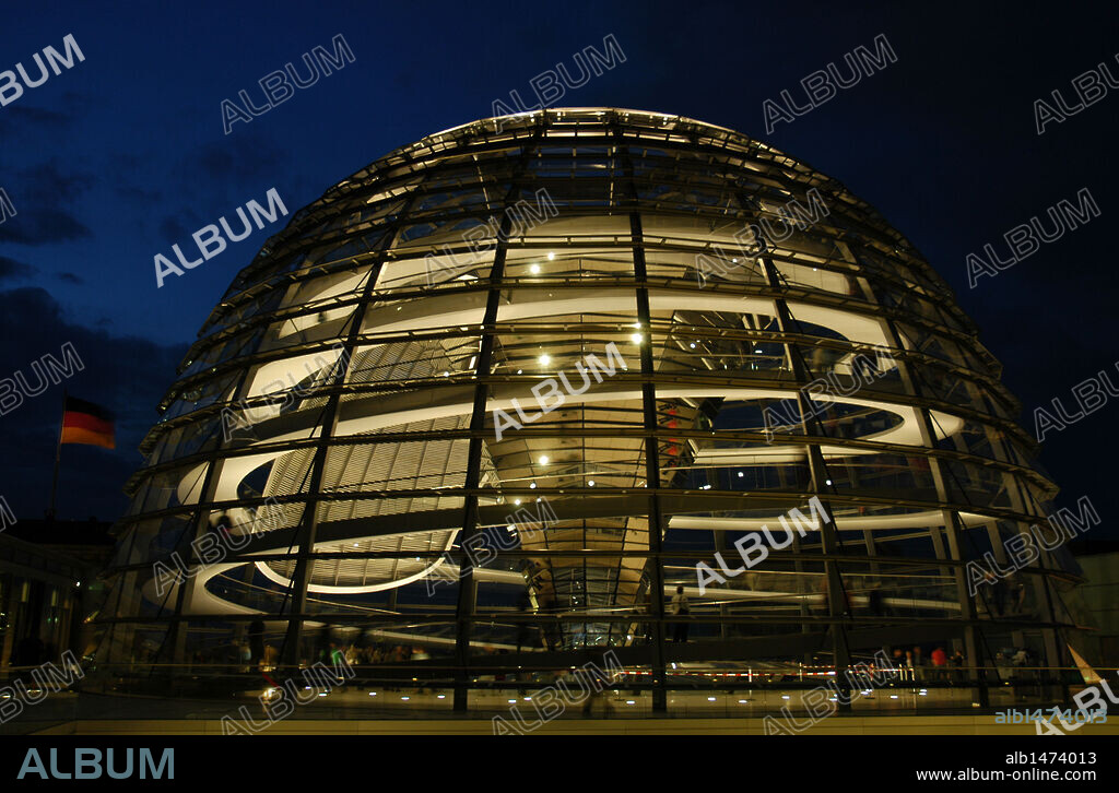 Dome of the Reichstag, seat of the German Parliament, designed by Norman Foster (b.1935). Interior. Night. Berlin. Germany.