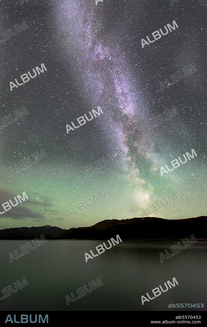 Aurora borealis and Milky Way above Fish Lake, Whitehorse, Yukon, Canada.