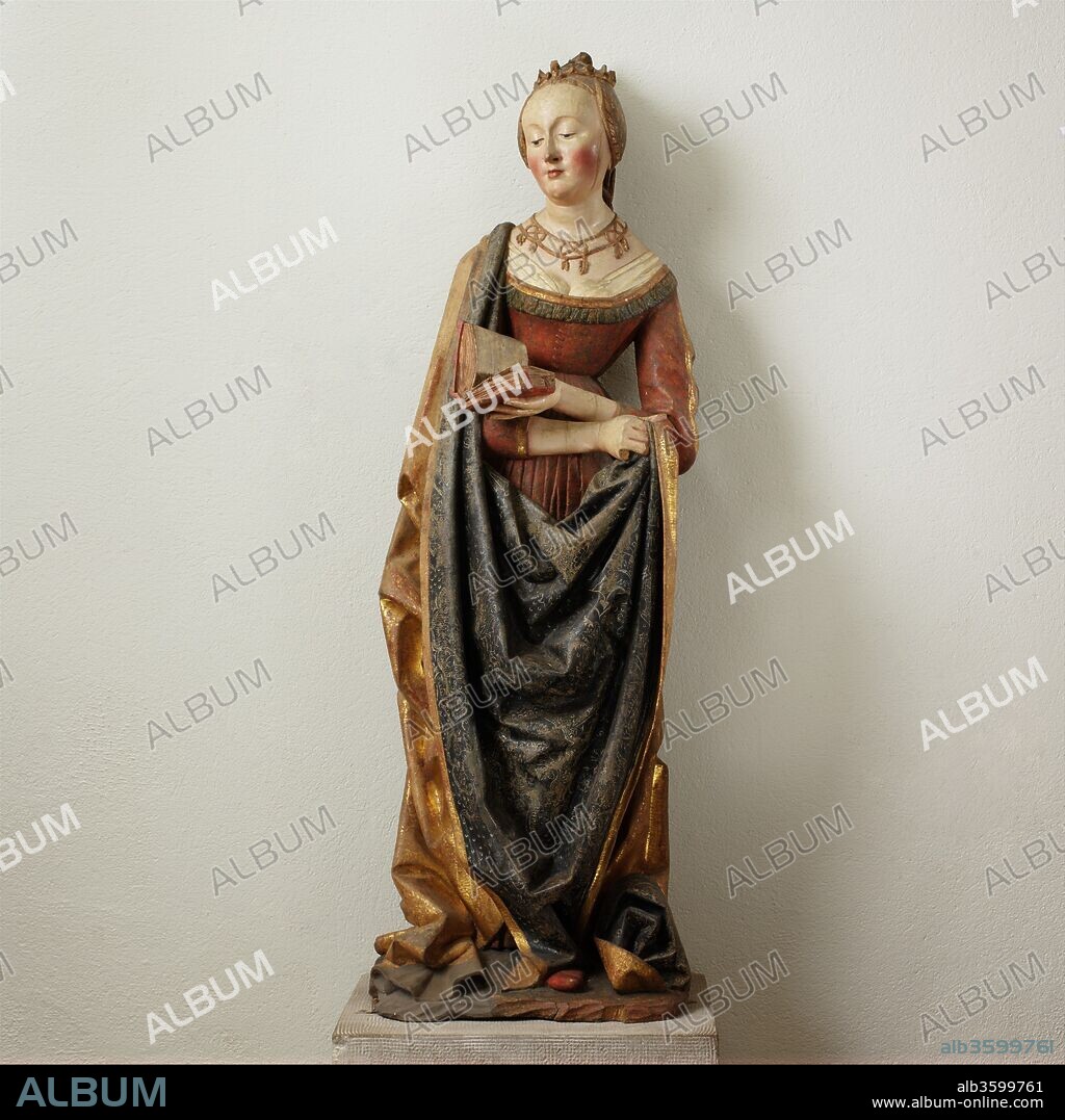 Saint Barbara. Culture: German. Dimensions: 50 1/4 × 17 × 13 1/4 in., 63 lb. (127.6 × 43.2 × 33.7 cm, 28576.613g). Date: ca. 1490.
This well-preserved figure of Saint Barbara came from the central shrine of the high altarpiece of the church of Saint Mauritius on the east side of the Rhine River, south of Strasbourg. The central shrine was dismantled prior to the early seventeenth century, and the sculptures were consigned to the charnel house in Kippenheim. The now-dispersed figures and the painted wings have survived, allowing for the reconstruction of the altarpiece. Dedicated to the Virgin, the central and larger group of the Virgin and Child occupied a niche of extended height and was flanked by Saints Mauritius and Catherine on the left and Saints Barbara and Gregory the Great on the right. The outer wings represented the Annunciation and the Visitation, and the inner wings showed the Nativity and the Adoration of the Shepherds. 
This sculpture retains much of its original paint and appliqué decoration; the red dress is enhanced with molded and gilt-wax brocade patterning, and the fine decoration on the mantle was achieved by etching through a transparent indigo layer over silver.