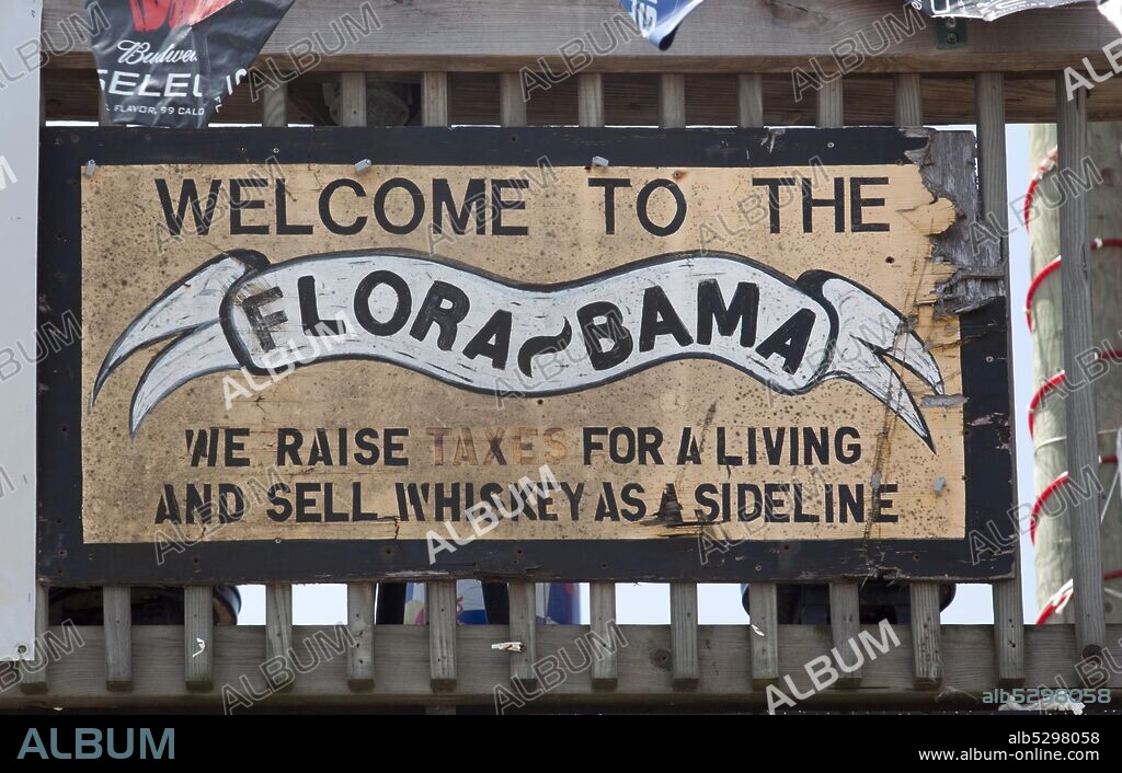 The Flora-Bama takes its name from its location on the Florida-Alabama border line. The bar is in fact located all within Florida, with the Alabama line being about six feet from the western outside wall. Contrary to what some might describe it as, it is not a nightclub. It is a beach bar..
