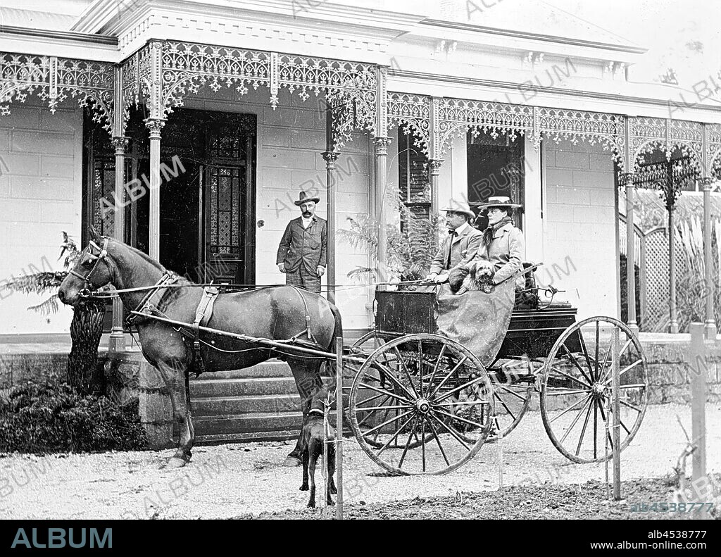 Negative - Mr & Mrs J.G. Affleck in a Horse & Buggy Outside Their Home, Ballarat, Victoria, circa 1895, Mr and Mrs J.G. Affleck in a horse and buggy in front of their home. A second man is leaning against a verandah post.
