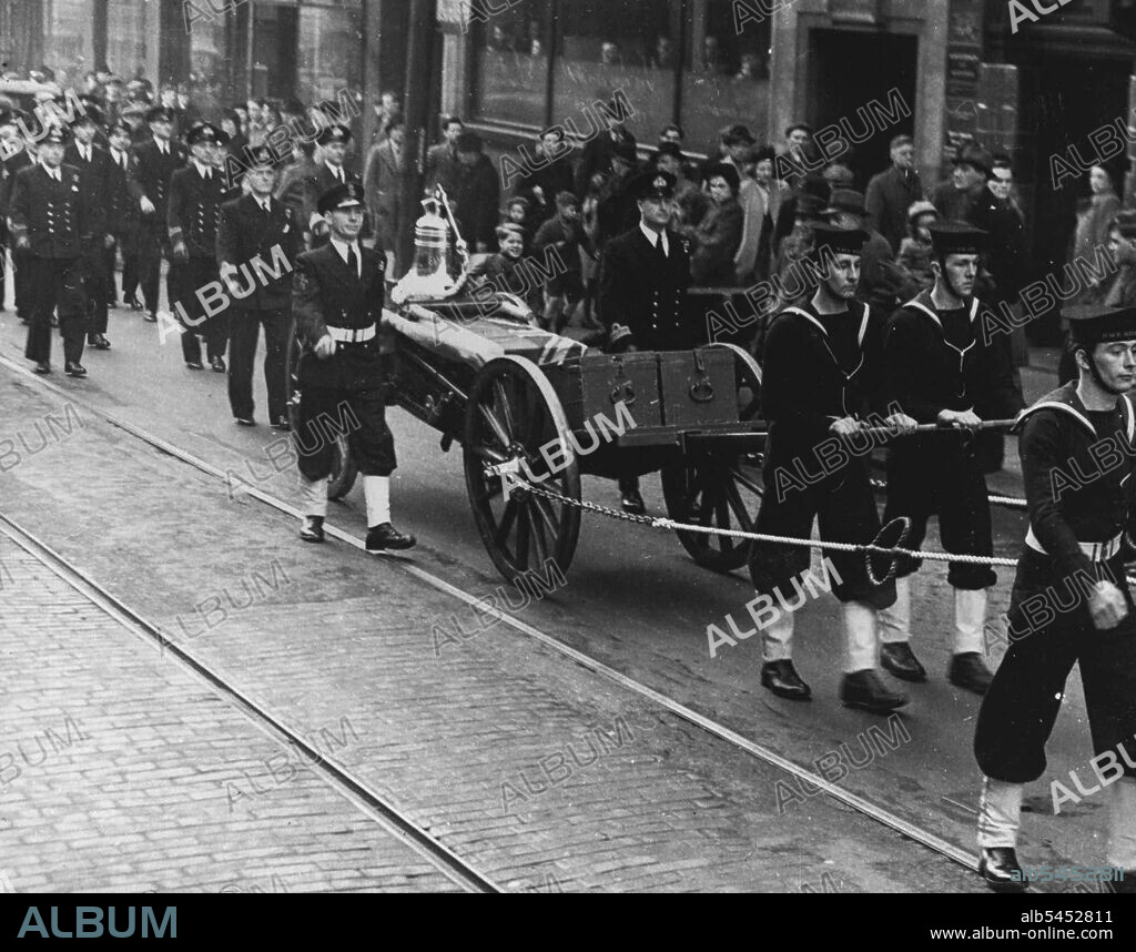 "Nelson's Bell" -- The Nelson's bell is borne on a gun-carriage with Naval escort through the streets of Newcastle, to be presented to the Newcastle Corporation.
The ship's bell of H.M.S. Nelson, the famous Home Fleet flagship which is to be broken up, has been presented to the people of Newcastle-on-Tyne where she was built in 1922. February 18, 1948.