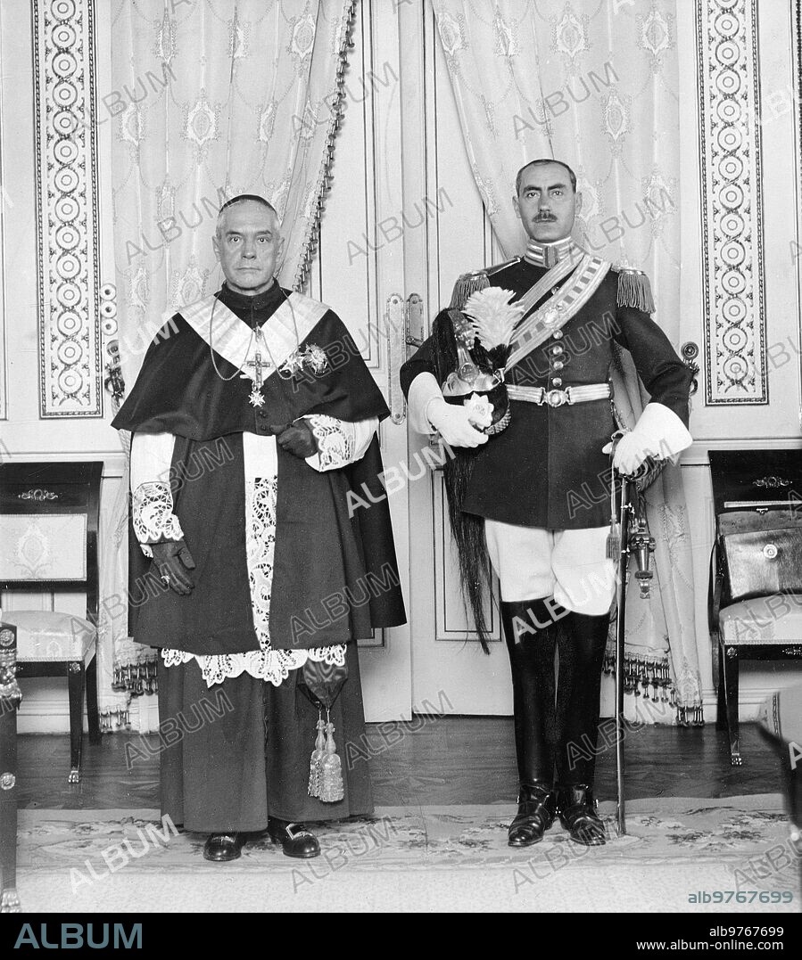 December 24, 1922. Madrid. In the palace of the Nunciature. His Eminence the Cardinal Archbishop Dr. Reig, with the noble guard of His Holiness Count Angel Valentini, after the Cardinal's Birretta was Imposed on the First by HM The King.