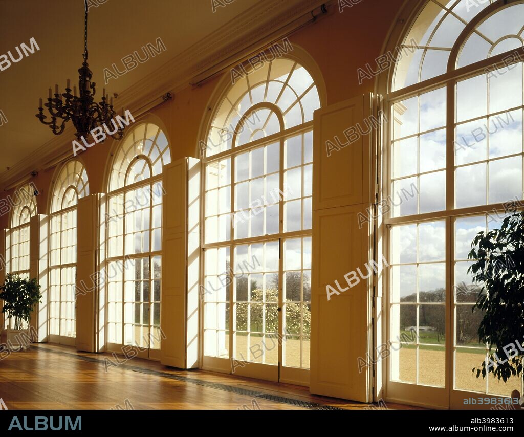 The Orangery, Kenwood House, Hampstead, London, 1995. An interior view of the Orangery at Kenwood House, with its virtual wall of glass. Through the arched windows can be seen a magnolia tree in flower, with the bridge over the lake in the distance. The Orangery was already in existence prior to Adam's remodelling of the house which began in 1764, but was altered externally in order to blend with the new facade.