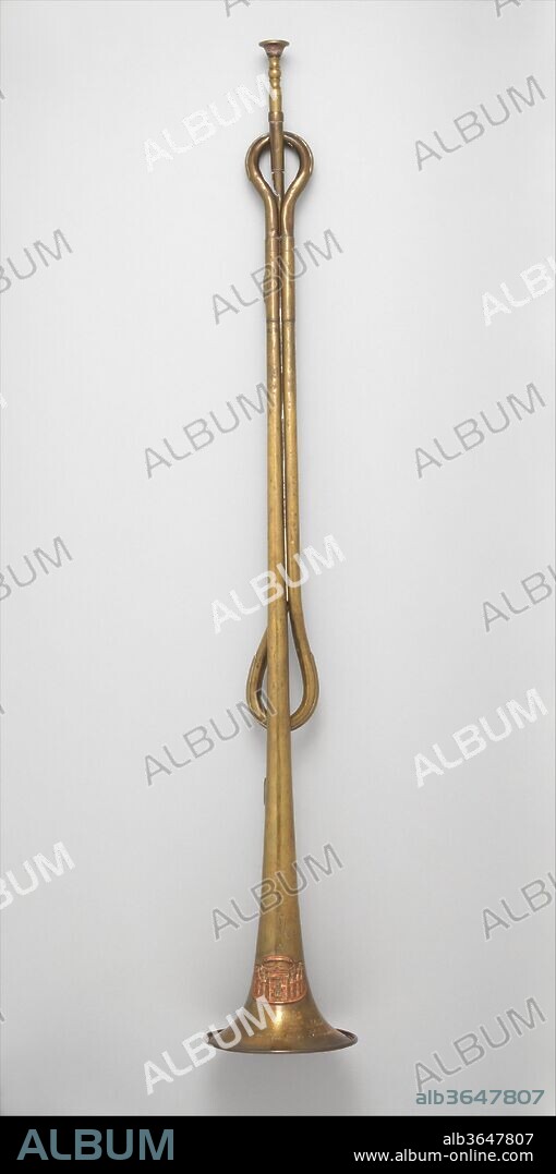 Fanfare trumpet in E-flat. Culture: French. Dimensions: Height (Without mouthpiece): 32 3/8 in. (82.2 cm)
Diameter (Of bell): 5 5/16 in. (13.5 cm). Maker: Adolphe (Antoine Joseph) Sax (Belgian, Dinant, Belgium 1814-1894 Paris). Date: 1856.
The form of this parade trumpet was inspired by the ceremonial trumpets of ancient Greece and Rome. Sax initially devised the instrument in 1852 for use in L'Escadron des Cent Gardes of Emperor Napoleon III. 
This instrument was part of a set of parade trumpets supplied to Wynendaele Castel in Tourhout, Belgium that probably consisted of at least 15 instruments. Four other instruments from this set survive in the Musical Instruments Museum in Brussels. All of these instruments bear a bas-relief copper badge on the bell depicting Wynendale Castle and have been engraved with a large initial M. This refers to the Belgian banker Josse-Pierre Matthieu, who purchased Wynendaele Castle in 1833 and restored it after its destruction by the French Revolutionary Army, or to his son Joseph Louis Matthieu, who remodeled the castle in 1877. The parade trumpet at the Metropolitan Museum is the only one of these instruments to bear the AIS mark.
The date of the surviving parade trumpets from the Wynendaele set has been the focus of much research. The serial numbers establish the year of manufacture as 1856. The trumpets were part of a batch of unsold instruments that remained in Sax's stock. Each has been subsequently stamped SEUL/GRAND PRIX/ 1867 to note Sax's success at the Universal Exhibition in Paris. The depiction of Wynendaele Castle on the bells of these instruments shows the façade of the castle after it was remodeled in a romanticized, neo-gothic form by Joseph Louis Matthieu in 1877. This suggests that the set of trumpets was purchased to commemorate the reopening of the castle. The four instruments in the Musical Instruments Museum in Brussels were subsequently acquired by Caesar Snoeck and are described in his 1903 Catalogue de la collection d'instruments de musique Flamands et Néerlandais formée par C.C. Snoeck. Little is known of the provenance of the parade trumpet given to the Metropolitan Museum. Early records indicate that the case of this instrument, which no longer survives, was marked "Ghent", perhaps suggesting a link with Snoeck.