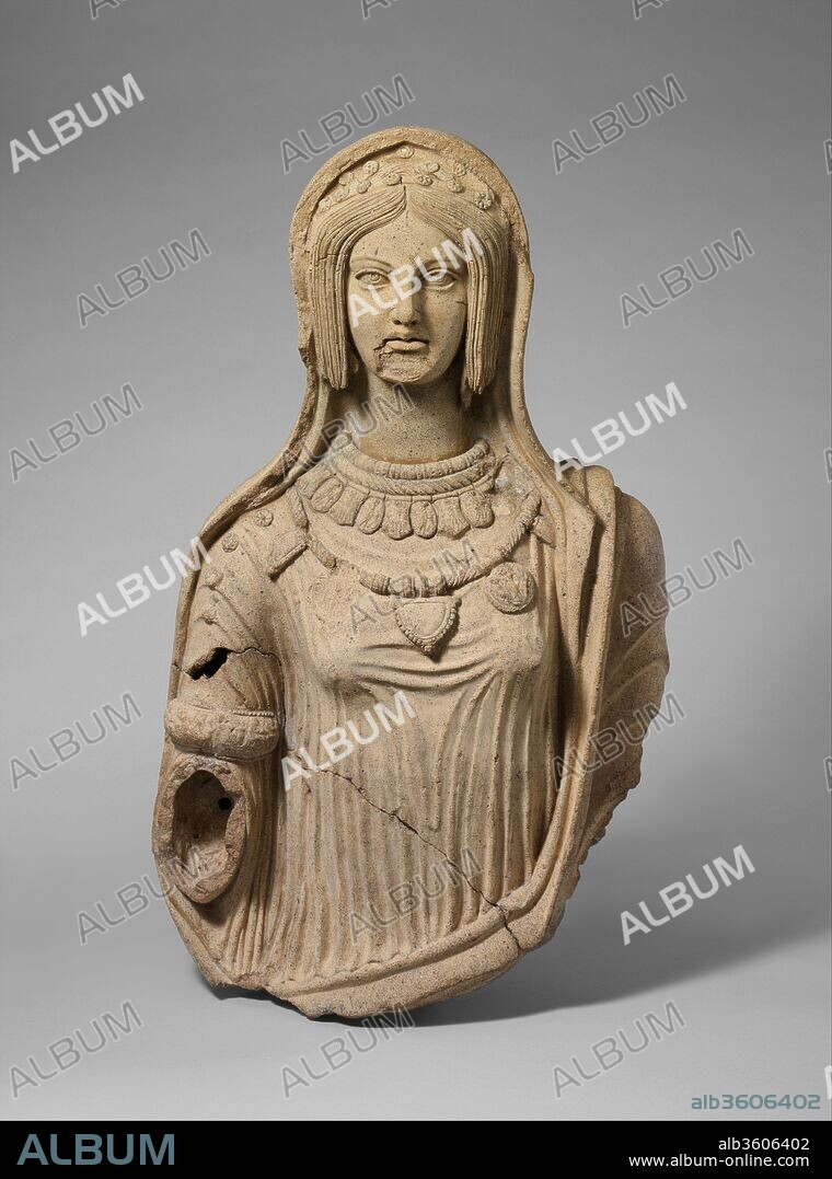 Terracotta statue of a young woman. Culture: Etruscan. Dimensions: H. 29 7/16 in. (74.8 cm). Date: late 4th-early 3rd century B.C..
The legendary king Aeneas, father of the Latin race, fled from Troy to Macedonia, then Sicily, and finally to the Italian peninsula. There he founded a city called Lavinium (modern Pratica di Mare), a site eighteen miles south of Rome, which became a major religious center for the Latin people. The distinctive clothing and jewelry on this life-sized statue closely resemble those on fourth and third century B.C. terracottas found there. The elaborate necklaces and armband appear to be reproduced from molds of actual jewelry. Some of the pendants are decorated with reliefs depicting various Etruscan deities and heroes. Originally, this woman wore a pair of grape-cluster earrings. The one on her left ear is visible behind her long hair. When complete, the statue probably stood in a sanctuary and showed the young woman holding an incense box in her extended right hand. This rare statue is an exceptional example of the awakening sophistication of Italic artists, who over the following two centuries fused native traditions with imported ones and gave birth to the multifaceted art of Late Republican Rome.