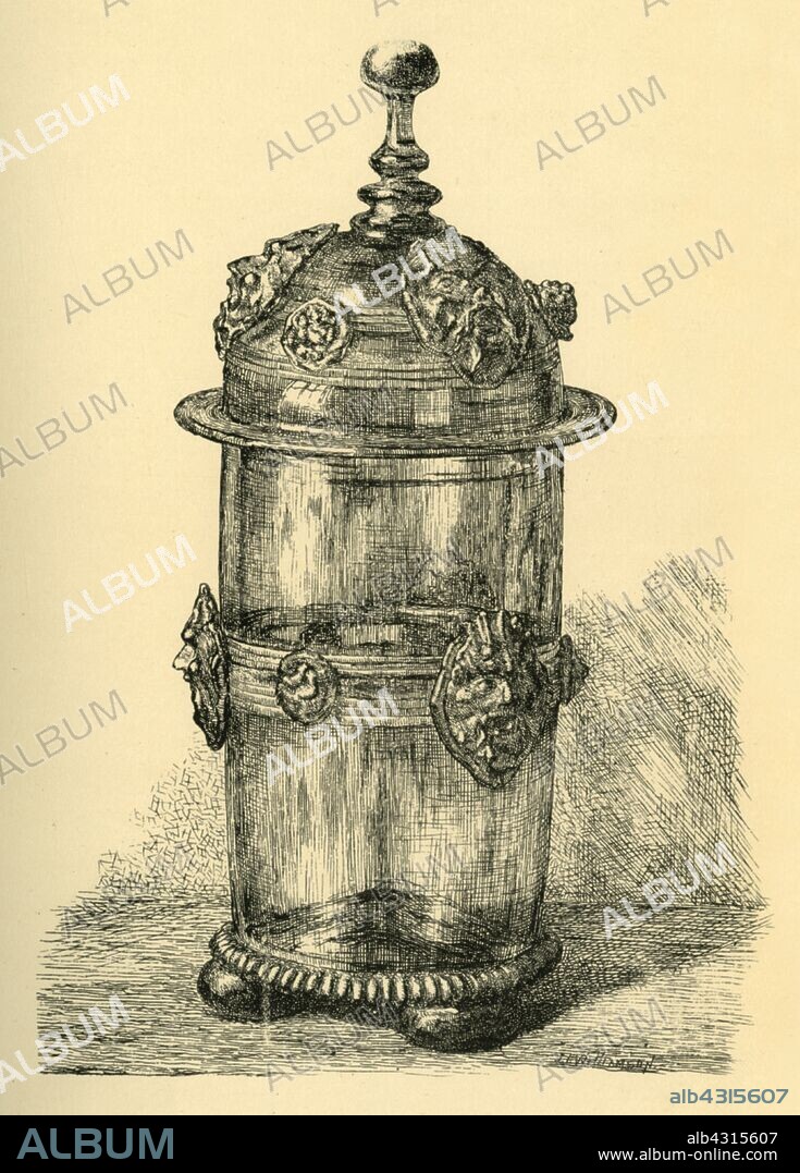 J. I. WILLIAMSON. Glass beaker and cover, 1550-1620, (1881). Etching of a gilt drinking glass with moulded gilt decoration, made in the Southern Netherlands in the mid-late 16th century-early 17th century. From "The South Kensington Museum", a book of engraved illustrations, with descriptions, of the works of art in the collection of the Victoria & Albert Museum in London (formerly known as the South Kensington Museum). [Sampson Low, Marston, Searle and Rivington, London, 1881].