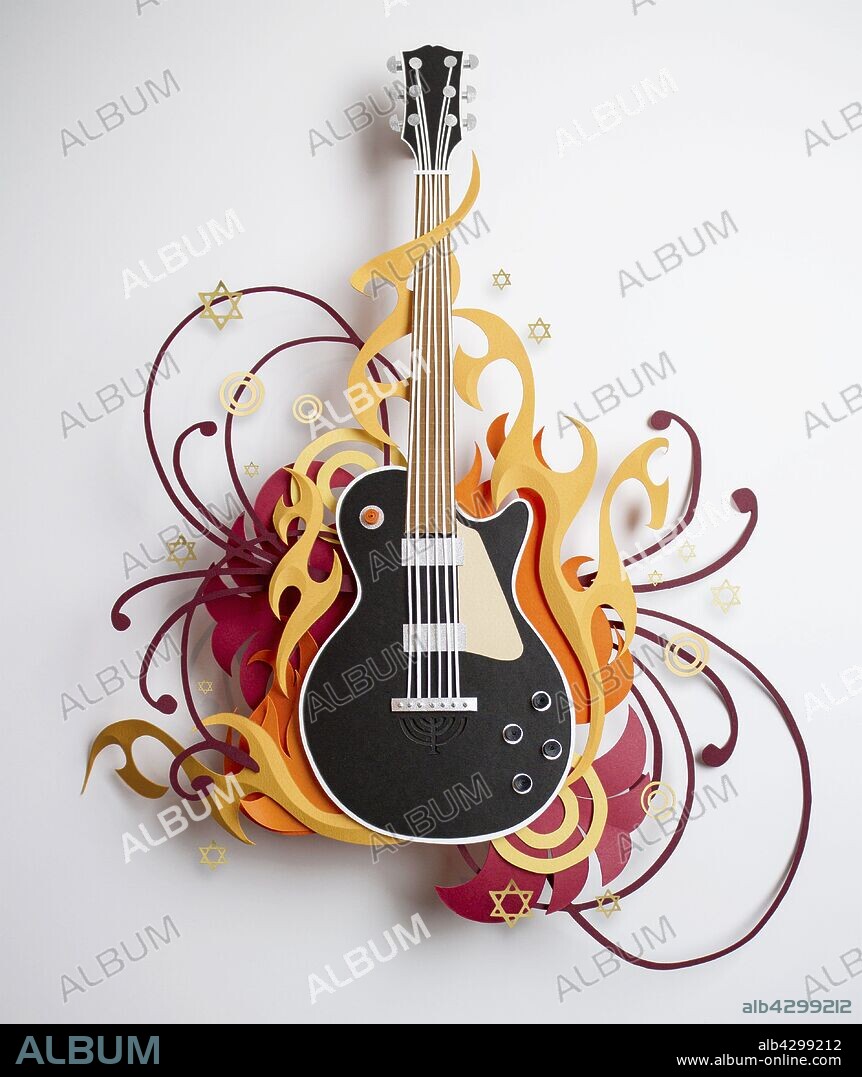 Stars and swirls surrounding paper craft guitar.