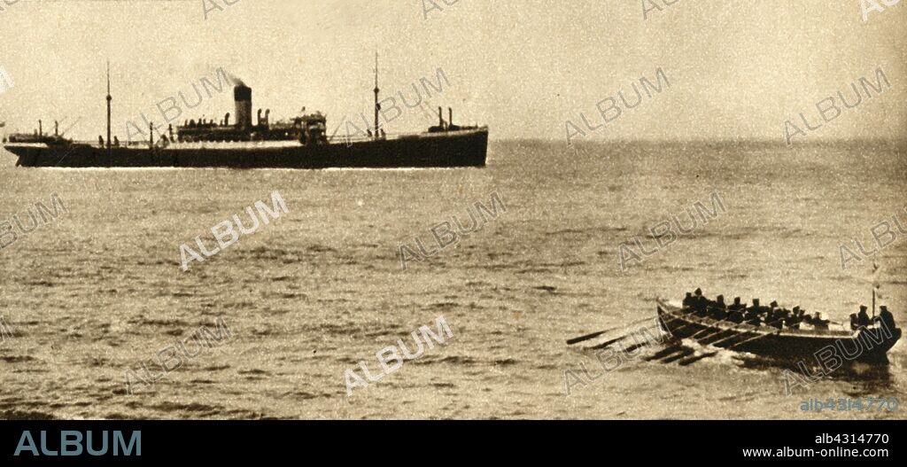 Royal navy cutter about to examine a ship's papers, First World War, 1914-1918, (1933). 'Ceaseless vigil was maintained on the high seas by Britain's sailors, lest any ship should take supplies to an enemy port. A cutter is here seen going alongside a merchantmen to examine the latter's papers'. From "The Pageant of the Century". [Odhams Press Ltd, 1933].