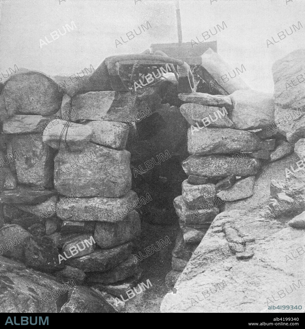 'Granite Hut, Cape Geology. Forde and Gran are cooking at the blubber stove, whose chimney projects behind the sledge roof tree', 1911, (1913). Rudimentary stone hut built amongst rocks at Granite Harbour. The final expedition of British Antarctic explorer Captain Robert Falcon Scott (1868-1912) left London on 1 June 1910 bound for the South Pole. The Terra Nova Expedition, officially the British Antarctic Expedition (1910-1913), included a geologist, a zoologist, a surgeon, a photographer, an engineer, a ski expert, a meteorologist and a physicist among others. Scott wished to continue the scientific work that he had begun when leading the Discovery Expedition to the Antarctic in 1901-04. He also wanted to be the first to reach the geographic South Pole. Scott, accompanied by Dr Edward Wilson, Captain Lawrence Oates, Lieutenant Henry Bowers and Petty Officer Edgar Evans, reached the Pole on 17 January 1912, only to find that the Norwegian expedition under Amundsen had beaten them to their objective by a month. Delayed by blizzards, and running out of supplies, Scott and the remainder of his team died at the end of March. Their bodies and diaries were found eight months later. From Scott's Last Expedition, Volume II. [Smith, Elder & Co., London, 1913].
