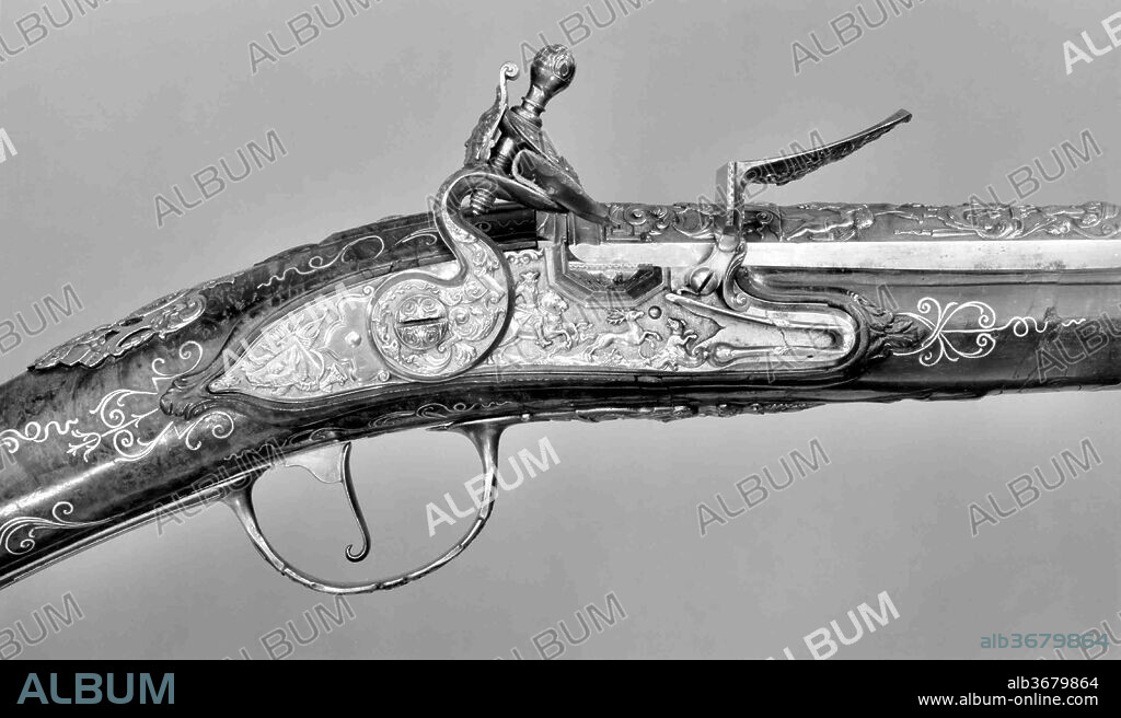 Flintlock Gun. Culture: German. Designer: Decoration follows closely designs of the engraver De Lacollombe (French, Paris, active ca. 1702-ca. 1736). Dimensions: L. 56 3/8 in. (143.2 cm); L. of barrel 41 1/16 in. (104.3 cm); L. of lockplate 5 7/8 in. (14.9 cm), Cal. .62 in. (15.8 mm); Wt. 6 lb. 10 oz. (3005 g). Date: ca. 1730-40.
Though unsigned, this beautifully crafted hunting gun appears to have been made by a German craftsman copying designs from firearms pattern books published in Paris in the early to mid-eighteenth century.