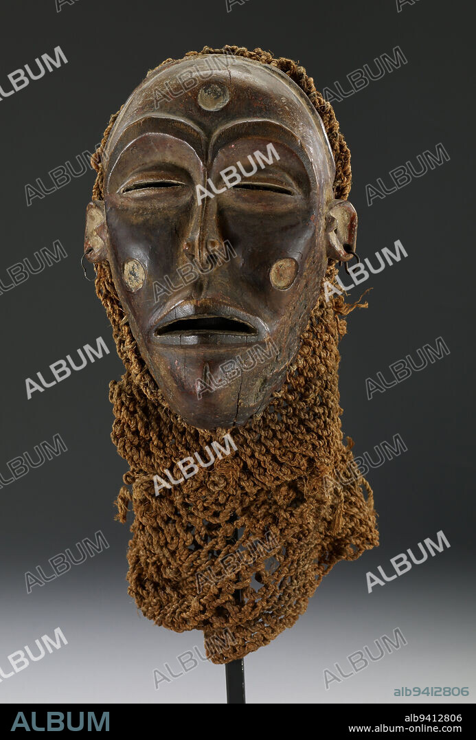 Mwana Pwo Mask, 20th century, 9 x 6 1/8 x 4 1/4 in. (22.9 x 15.6 x 10.8 cm), Wood, raffia, metal, Democratic Republic of the Congo, 20th century, The Mwana Pwo (young woman) mask represents the female ancestor of the Chokwe people. It embodies ideal feminine beauty and records traditional Chokwe facial scarification patterns.
