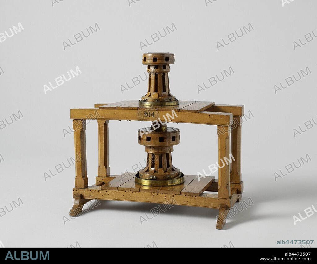 Model of a Double Capstan, Model of a double capstan in a wooden frame that represents two decks. The upper capstan is for eight wind trees, the lower for ten. Both have four catches in the foot against walking back. The upper capstan has a hollow wooden king, within which extends the elongated metal king of the lower capstan, with two iron keys through the upper drum, the two kings are connected to each other, so that the two capstans become one. When the keys are removed, one has two independent capstans. Scale 1:10 (estimate)., Rijkswerf Vlissingen (possibly), Flushing (possibly), c. 1821, wood (plant material), brass (alloy), iron (metal), model: h 38.5 cm × w 39.5 cm × d 28 cm packaging capsule: h 45.7 cm × w 82.3 cm × d 33.5 cm.