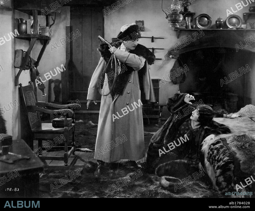 BETTY BOUTON and JOHN GILBERT in THE EXILES, 1923, directed by EDMUND MORTIMER. Copyright FOX FILM CORPORATION.