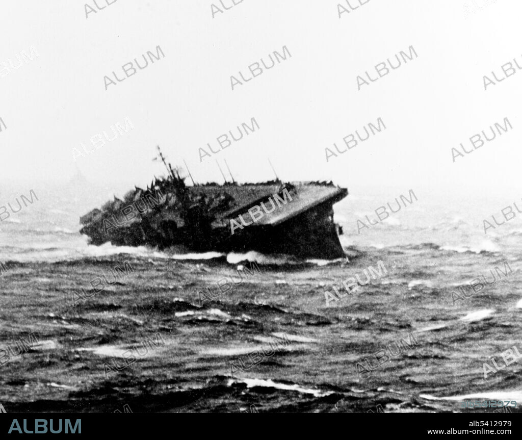 USS Langley (CVL-27) rolling sharply during extreme weather conditions in the Pacific. Typhoon Cobra was a powerful tropical cyclone that struck the US Pacific Fleet during WWII. The information given to Admiral Halsey about the location and direction of the typhoon was inaccurate. On December 17, 1944, Halsey unwittingly sailed the Third Fleet into the center of the typhoon. Because of 100 mph winds, high seas, and torrential rain, three destroyers capsized and sank with 790 lives lost. Nine other warships were damaged, and over 100 aircraft were wrecked or washed overboard. (cropped and cleaned).