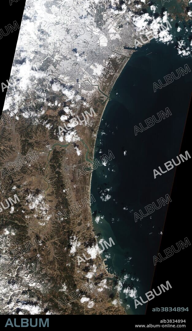 A swath of agricultural fields lies between the Japanese city of Sendai and Sendai Bay, and the area was one of the hardest hit by the tsunami on March 11, 2011. This natural-color image of the area was taken on March 18, 2011. One week after the magnitude-9.0 earthquake and resulting tsunami, the fields nearest the ocean were still covered with standing water. On the outskirts of the Sendai suburbs, fields that had escaped inundation or had already drained were later covered with snow, as was much of the Sendai metropolitan area when a cold front brought winds and snow to northeastern Japan.