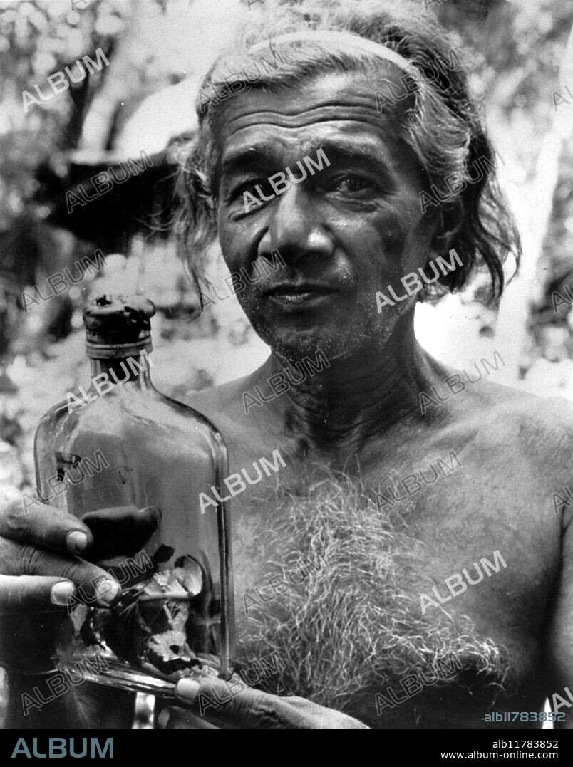 Sri Lankan witch doctor (Kattadiya) holding bottle containing evil demon which has been exorcised from a possessed person.It will be thrown into the Indian Ocean where it can do no further harm.