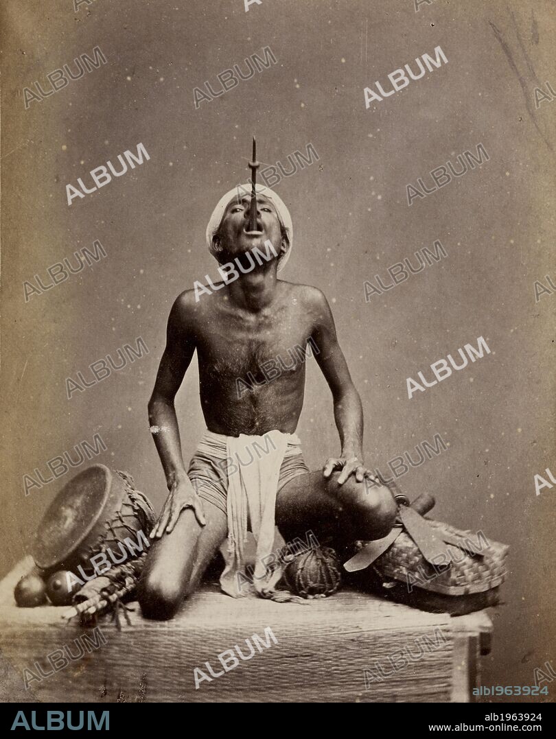 Photograph of an Indian juggler performing the sword-swallowing trick, Madras. A performance or trick. . Juggler performing the sword-swallowing trick, Madras. Probably shown at the Vienna Exhibition of 1873. Studio portrait of juggler, with only the hilt of his sword protruding from his mouth. Source: Photo 1000/52 4964.