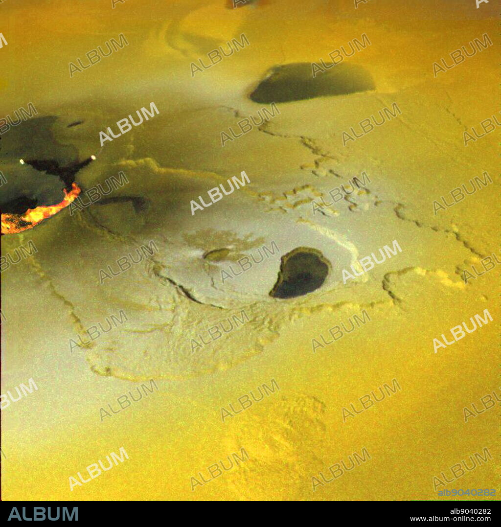 An active volcanic eruption on Jupiter's moon Io was captured in this image taken on February 22, 2000 by NASA's Galileo spacecraft. Tvashtar Catena, a chain of giant volcanic calderas cantered at 60 degrees north, 120 degrees west, was the location of an energetic eruption caught in action in November 1999. A dark, 'L'-shaped lava flow to the left of the centre in this more recent image marks the location of the November eruption. White and orange areas on the left side of the picture show newly erupted hot lava, seen in this false colour image because of infrared emission. The two small bright spots are sites where molten rock is exposed to the surface at the toes of lava flows.