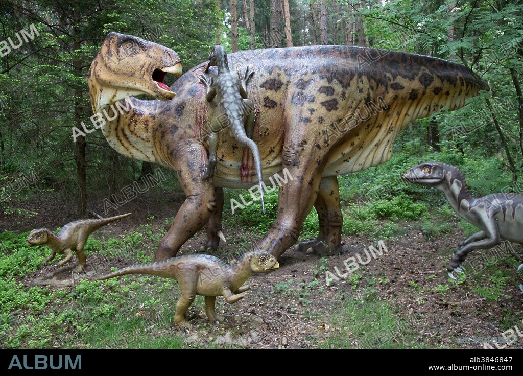 Edmontosaurus, an extinct duck-billed dinosaur of the Cretaceous Period, being attacked by little raptors in Dinosaurier Park, Germany.