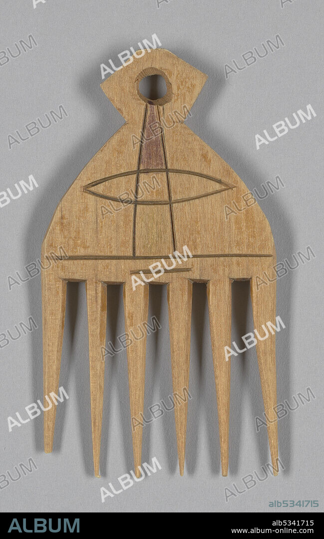 It had been assumed that the afro comb was invented in the 1970s when the afro hairstyle became popular in the West, along with the 'Black is beautiful' movement. However this type of comb actually dates back to ancient Egypt. Afro pick comb from Ghana in West Africa, made of light coloured wood. It is not glossy and has probably not been treated. Of the six teeth, one on the far left is broken off near the tip. There is an abstract design incised into the front of the comb. The top part of the design near the top of the handle of the comb is colored in a purple color. There is a hole at the end of the handle. A piece of masking tape with [GHANA] written in black ink is stuck to the reverse.