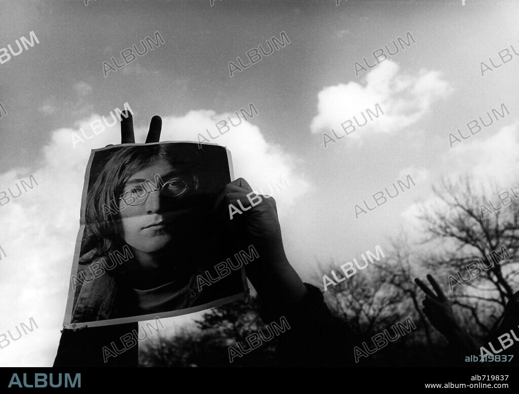 Beatles frontman and mystic being John Lennon was shot Dec. 8th 1980. On this night aroung 11pm 5 shots rang out 4 hitting a pedestrian point blank while 25 yr. old Mark David Chapman clutches a red paperback copy of 'Catcher in the Rye' in one hand and asmoking .38 calibre in the other while watching his victim bleed to death in the street, that victim was John Lennon. Fans gather to 'Remember' the legend. 08/12/1980